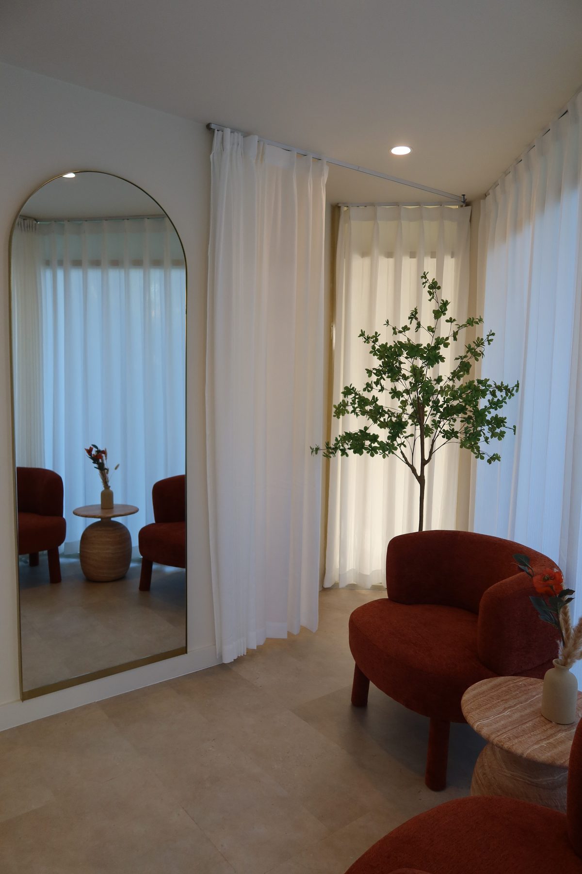 The atelier, arched mirror and boucle chair